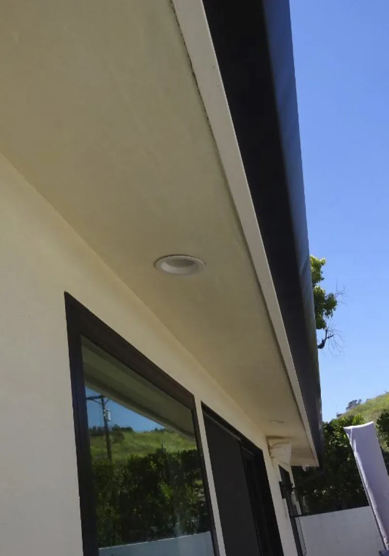 Enclosed eave soffit with recessed lighting and noncombustible materials